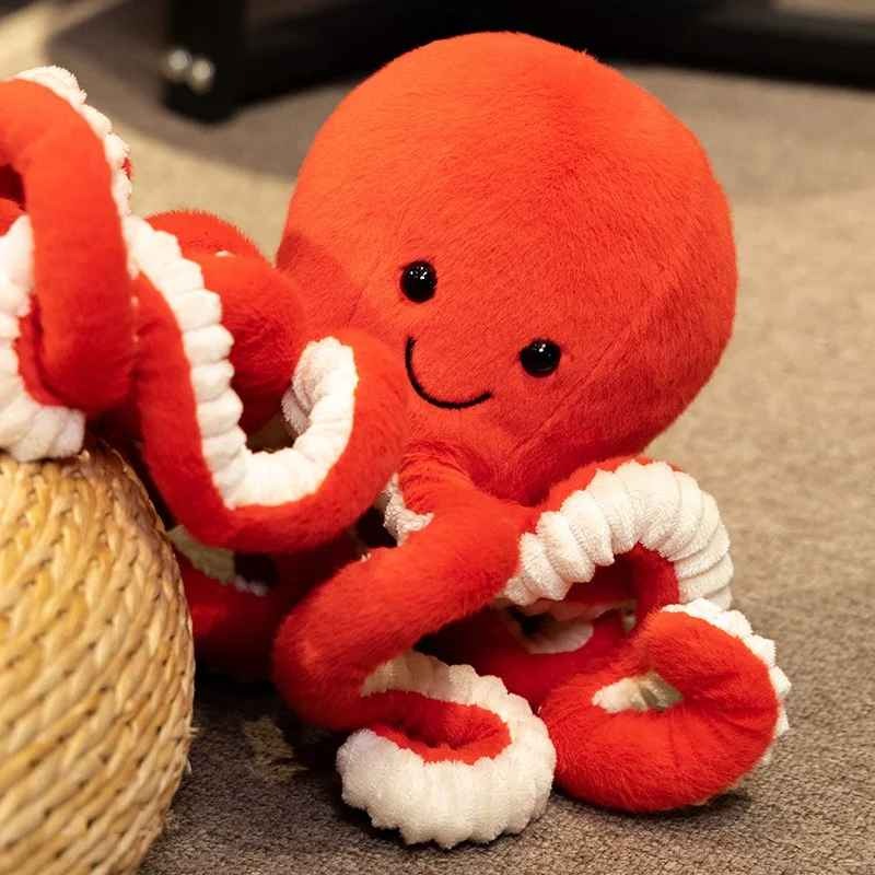 Peluche Pieuvre souriante tentacules bouclees Doudou apaisant Orange