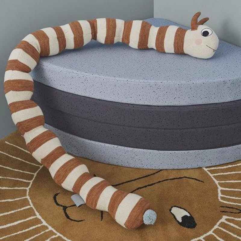 Tour de lit bébé en forme chenille sur un tapis Douceur Protectrice