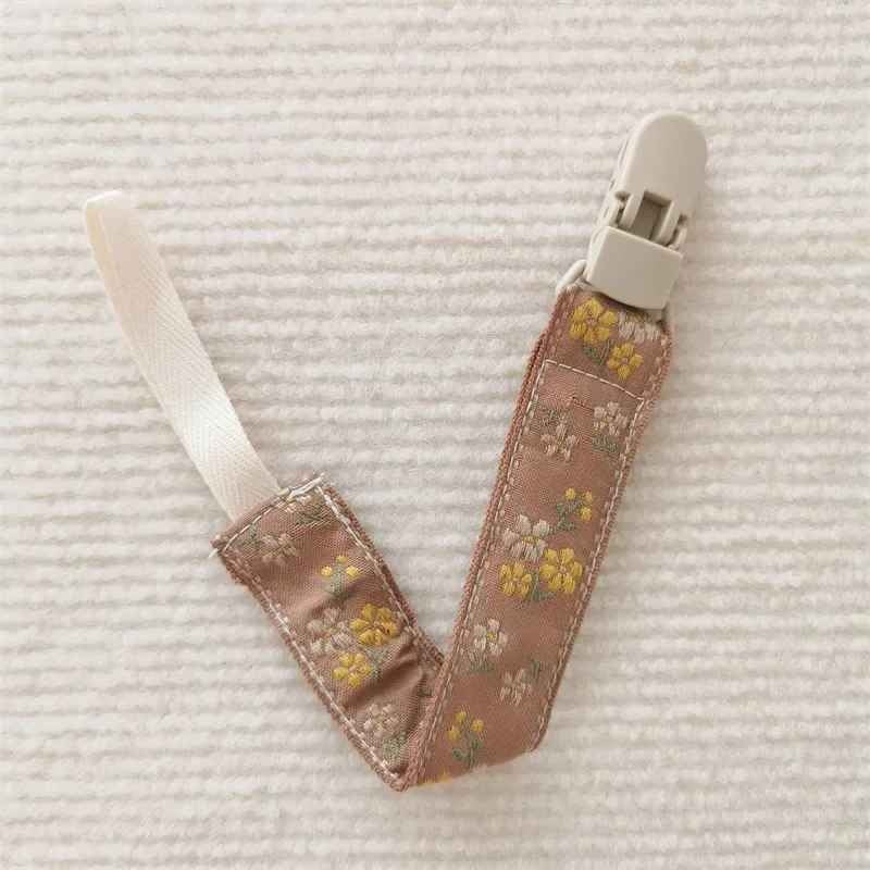 Attache tetine marron Sécurité Stylée