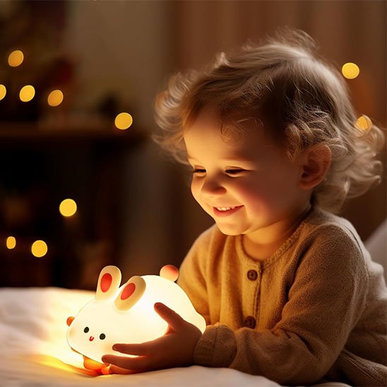 Bébé joyeux joue avec Veilleuse bebe en forme de lapin - Nuits Apaisantes