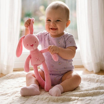 bébé s'amuse paisiblement avec Doudou lapin rose - Ultra-doux